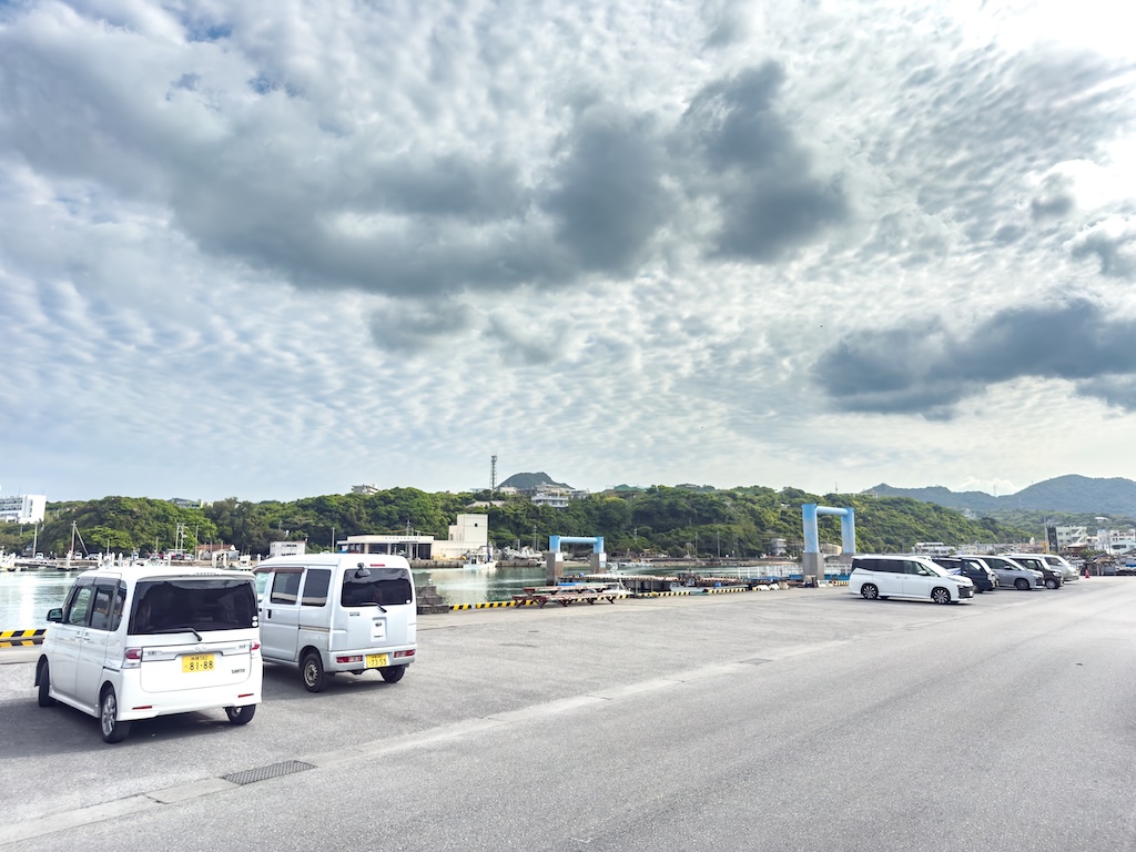 水納島浮潛出發點 — 渡久地港的停車場與停靠中的快艇